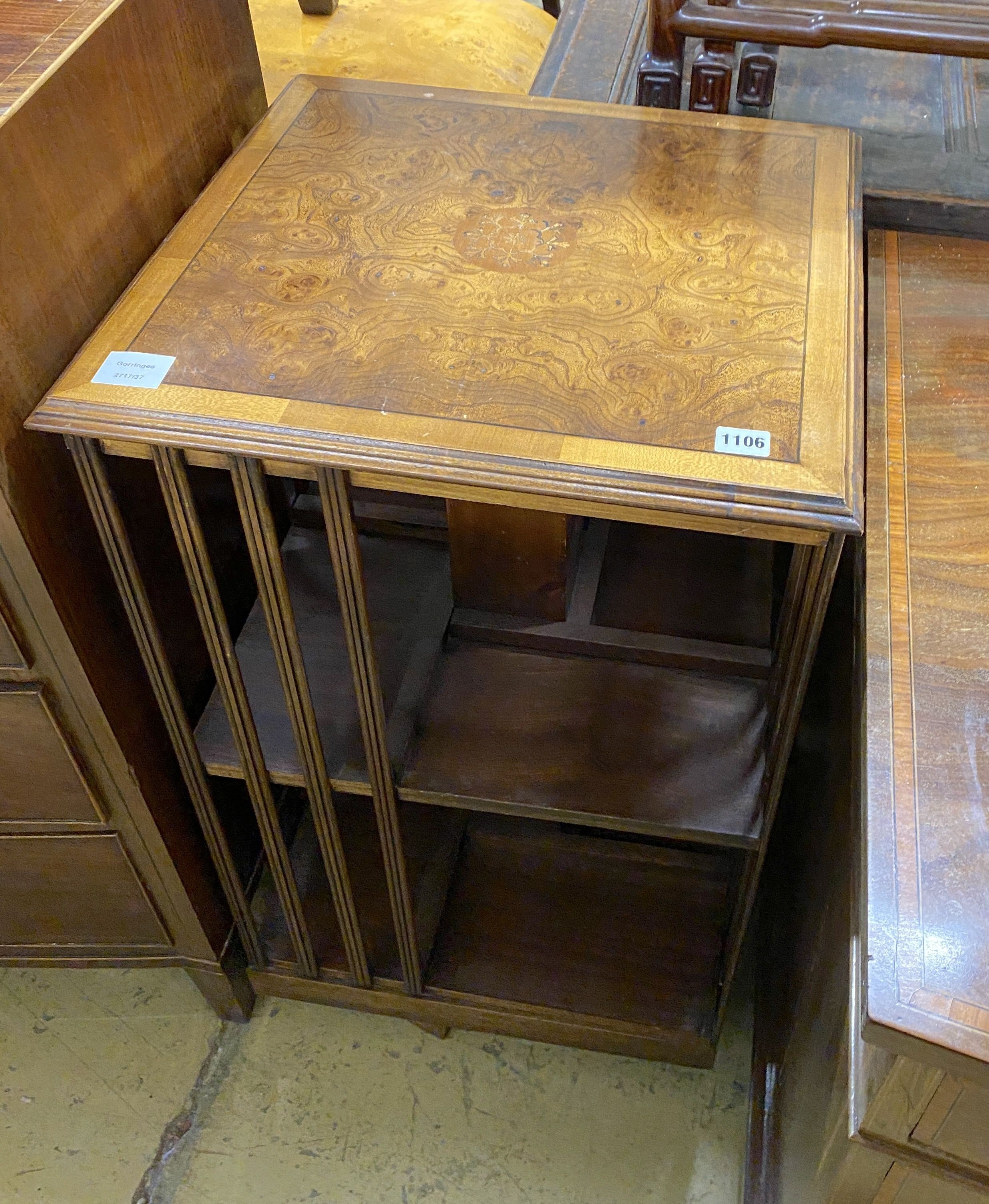 An Edwardian square cross banded elm revolving bookcase, width 48cm, height 83cm